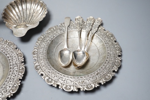 A late Victorian silver butter shell, a later silver sauceboat, seven assorted silver teaspoons including Scottish and two continental white metal dishes(a.f.), gross 16.5oz.